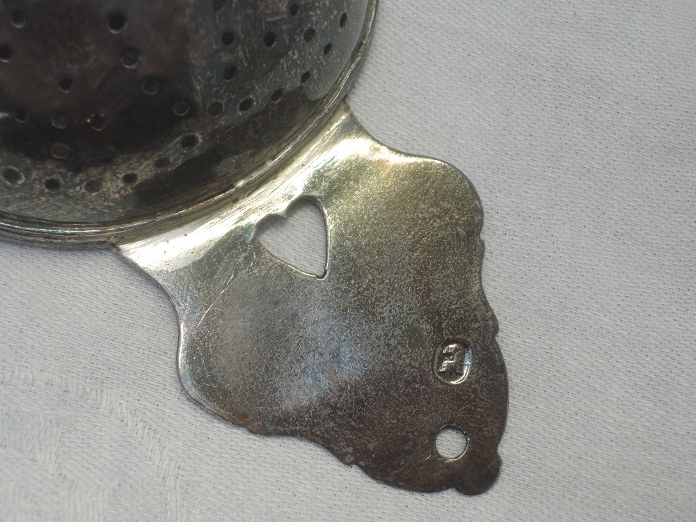 A Queen Anne Britannia silver lemon strainer having pierced bowl and heart cuts to the handles, - Image 6 of 10