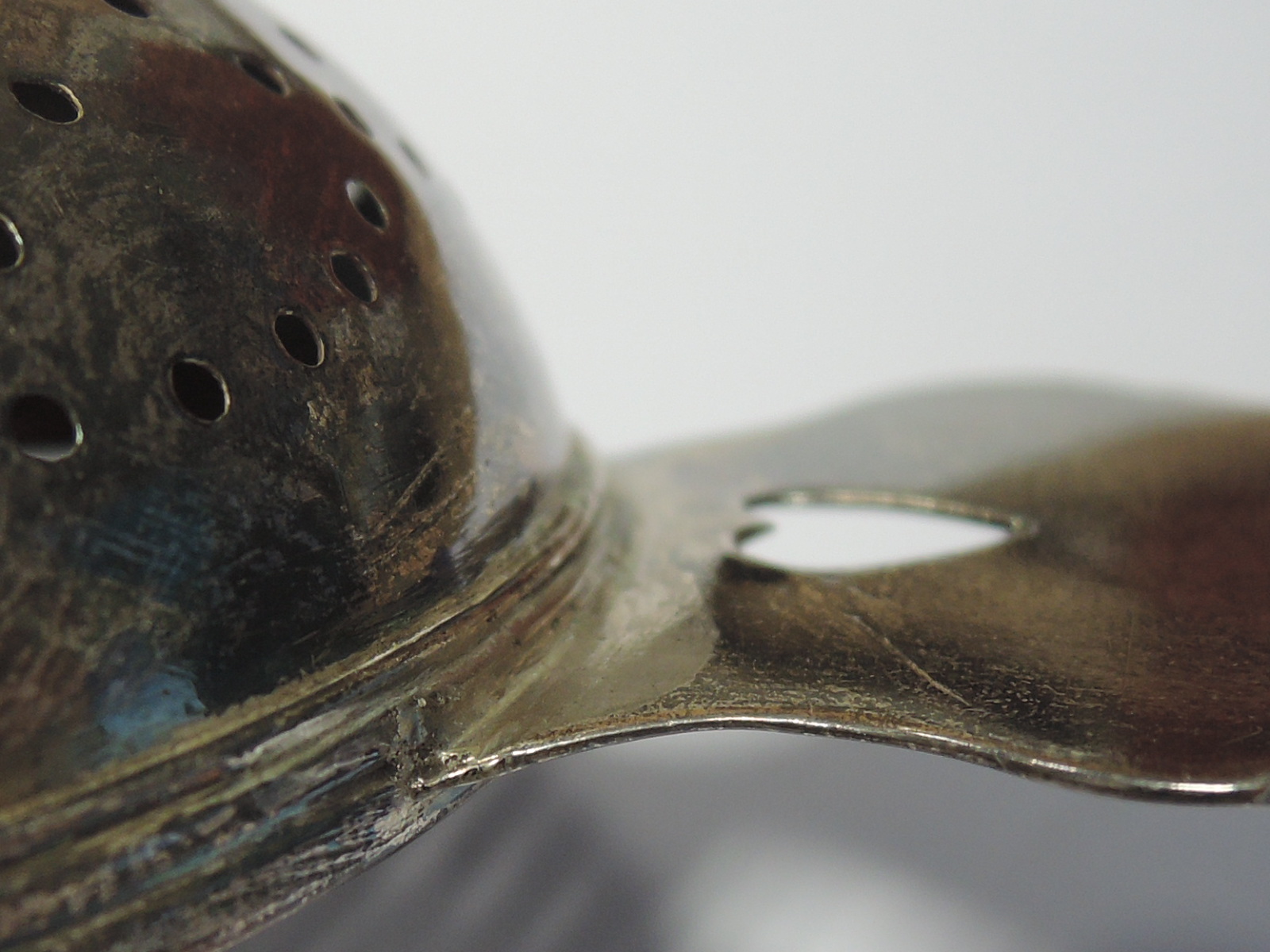 A Queen Anne Britannia silver lemon strainer having pierced bowl and heart cuts to the handles, - Image 9 of 10