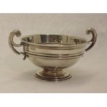 An Edwardian silver trophy bowl of small form having moulded loop handles, London 1903, Charles &