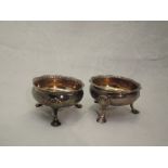 A matched pair of Georgian silver salts of circular form having trefoil hoof feet and frilled