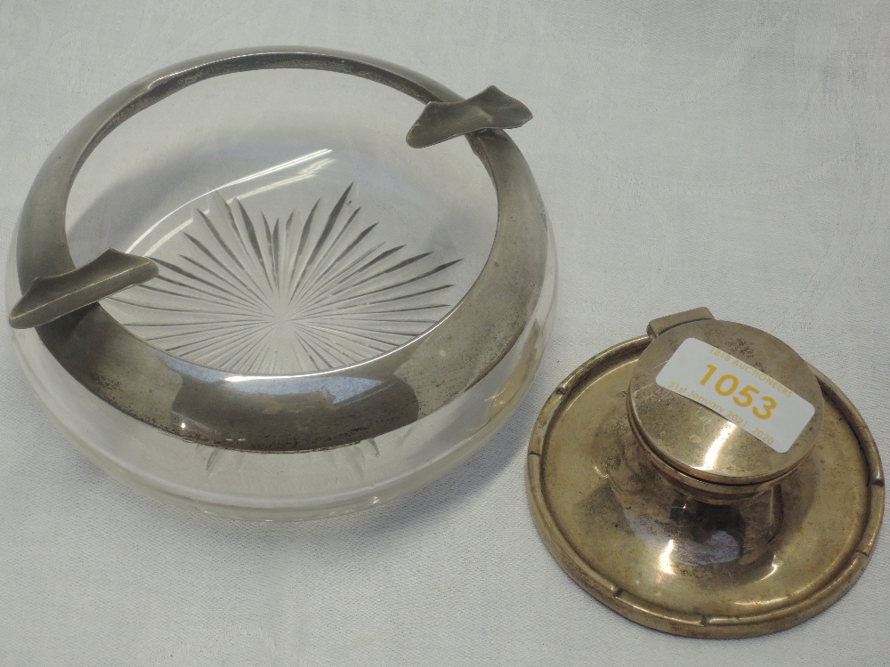 A silver capstan inkwell of plain form with raised rim and glass liner, Birmingham 1915, A & J