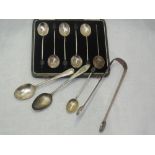 A cased set of six silver coffee spoons having coffee bean knops (1 missing), Birmingham 1930,