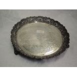 A Victorian silver card tray having heavily embossed raised rim, engraved decoration, initialled