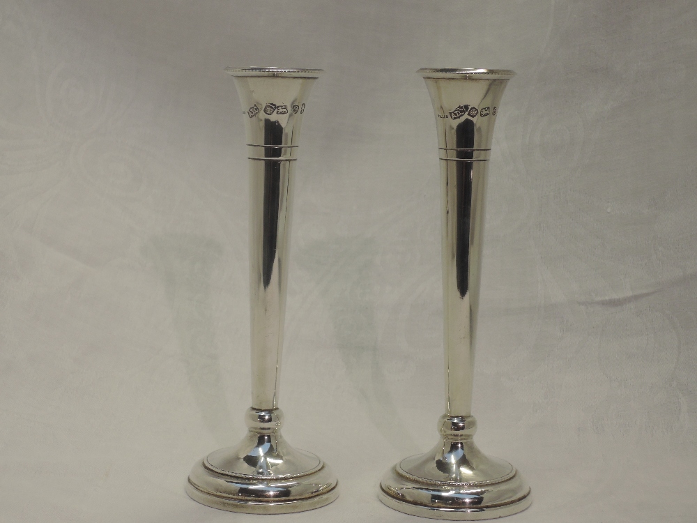 A pair of silver stem vases of classic trumpet form, with weighted bases and bearing oversized