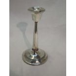 A silver candle stick of plain column form bearing monogram to weighted base, Birmingham 1913,