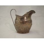 A Victorian silver cream jug of large form having gadrooned decoration to body, reeded loop handle