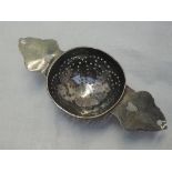 A Queen Anne Britannia silver lemon strainer having pierced bowl and heart cuts to the handles,