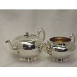 A Victorian silver teapot of plain compressed circular form having melon and leaf knop and