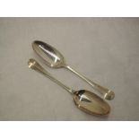 A pair of George II silver table spoons of hanovarian form having fan pattern to reverse of bowls