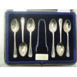 A cased set of six silver teaspoons with matching sugar nips having beaded decoration to stems and