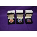 Three Morgan Mint Elvis Presley 2004 Silver Dollars in cases, each coloured on one side, each named,