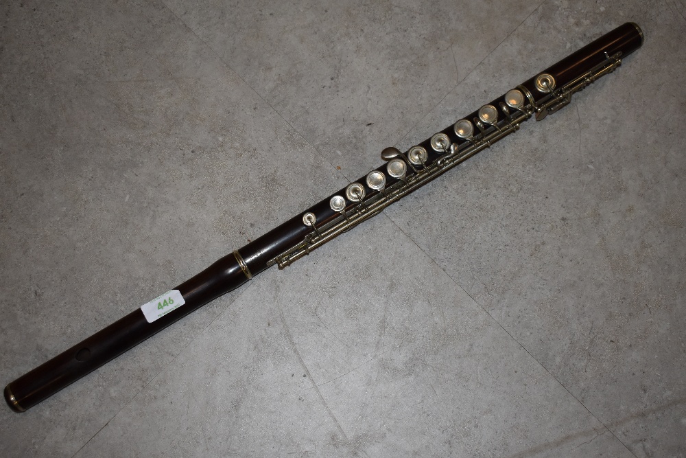 An early 20th Century hardwood flute, impressed mark J Wallis & Son, Euston Road, London,