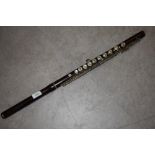 An early 20th Century hardwood flute, impressed mark J Wallis & Son, Euston Road, London,