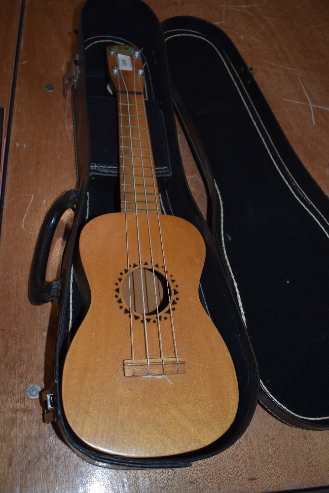 A vintage soprano ukulele , labelled Regal , in case