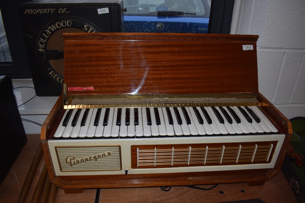 A vintage sapele cased electric Pianorgan II by Farfisa, complete with legs