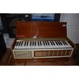 A vintage sapele cased electric Pianorgan II by Farfisa, complete with legs