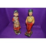 A pair of art deco chalk ware figurines of a boy and a girl.