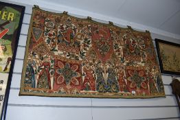 A wall hanging depicting horses, ladies in classical dress and floral motifs.