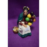 A Royal Doulton figurine of the old balloon seller having green back stamp