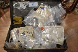 A vintage tin containing buttons and a tin of HMV gramophone needles.