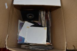 A box of 45rpm singles, including Iron maiden,Deacon blue, A-ha and more.