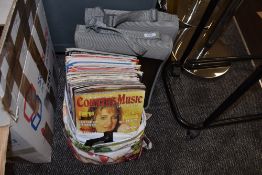 A collection of country music magazines and two cases.