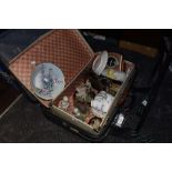 Two suitcase, one vintage and a mixed lot of figurines, cups and saucers and clocks within it.