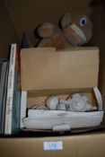 A box of general books, a childrens ceramic tea set and a zippy toy.