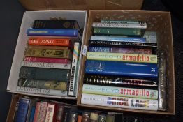 Two boxes of books predominantly novels.