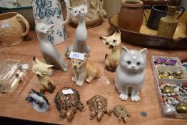 A collection of retro cats and three wade tortoises, one with removable shell lid.