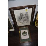 A framed Alsatian print and small signed painting of a cottage in woodland.