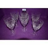 Six Stuart crystal wine glasses.