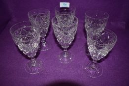 Six Stuart crystal wine glasses.