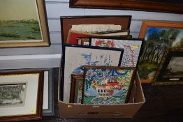 A box of needle works, prints and original art works.