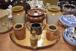 A mixed lot of vintage earthenware including jars,platter with drainage spout,lidded bowl and more.