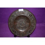 An antique bronze footed tazza or plaque decorated with cherubs and signs of the zodiac bearing