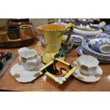 An art deco Victoria trio and milk jug, a Burleigh ware vase with bird to handle and yellow ground