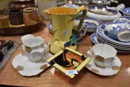 An art deco Victoria trio and milk jug, a Burleigh ware vase with bird to handle and yellow ground