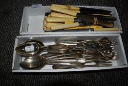 A collection of plated and stainless cutlery including sugar nips, knives, forks,spoons and more.