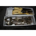 A collection of plated and stainless cutlery including sugar nips, knives, forks,spoons and more.