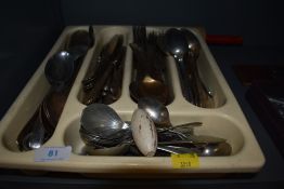 An assortment of vintage cutlery including cork crew , spoons and knives and forks.