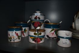 A selection of kitchen and condiment jars by Luzerner Keramik having hand decorated scenes