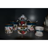 A selection of kitchen and condiment jars by Luzerner Keramik having hand decorated scenes