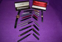 A collection of pens including a Parker 51 in grey,Parker slimfold in Maroon,black duo fold,parker