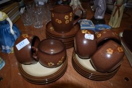 A selection of Denby tea cups and saucers in the Sandstone pattern