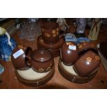 A selection of Denby tea cups and saucers in the Sandstone pattern