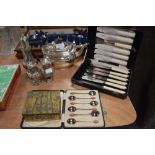 An assortment of plated ware and boxes of vintage cutlery including box of spoons with coffee