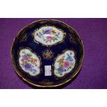 An antique pin dish having cobolt blue gold and hand decorated floral scenes bearing crossed