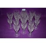 A collection of nine Stuart crystal wine glasses and seven sherry glasses.