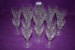 A collection of nine Stuart crystal wine glasses and seven sherry glasses.